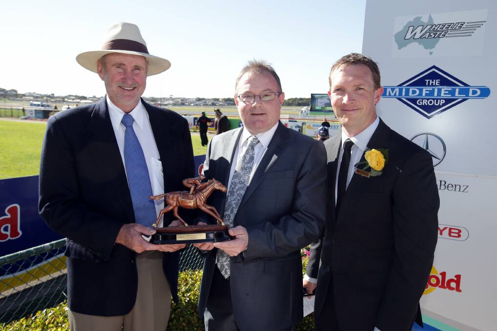 The Standard's general manager Tim Lewis (middle) awards trainer Darryl Dobson after his horse Midnight Express won Race 5, alongside committee member Stephen Waterhouse.