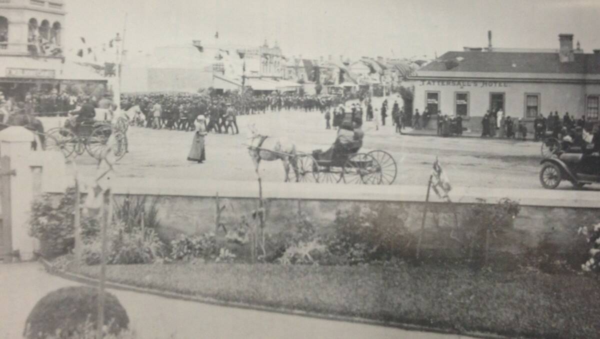 People gather along Liebig Street and Raglan Parade for the Anzac Day march in 1920. The photo was taken from what is now a doctor's surgery, looking over to the corner McDonald's currently occupies.