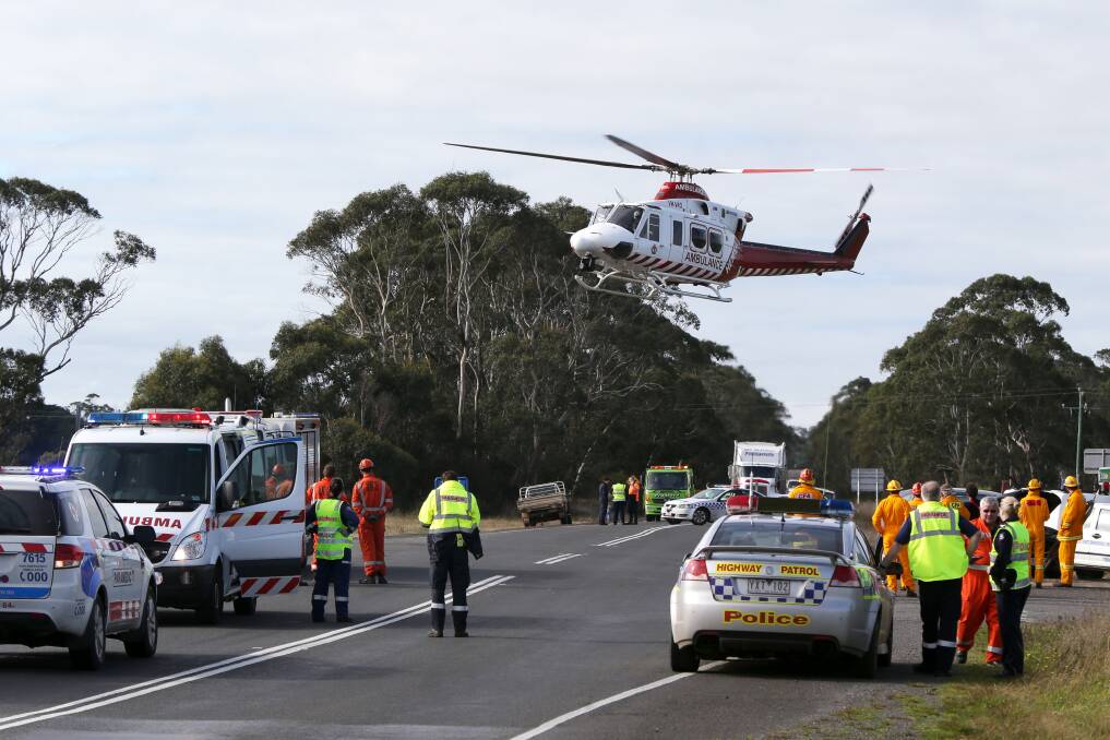 The HEMS-4 air ambulance lands at the site of an East Naringal two-car collision. Picture: ROB GUNSTONE.