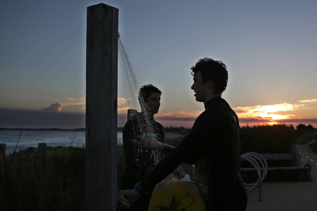 Bodyboarders Heath Brennan, 15, of Warrnambool, and Brad Whitehead, 15, of Dennington, enjoying the last of the afternoon sun, as spring approaches. Picture: ROB GUNSTONE
