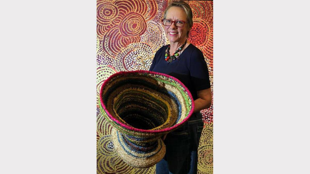 Aboriginal art collector Deborah Sims with some of the pieces in the exhibition, Strong Women, Strong Painting, Strong Culture.