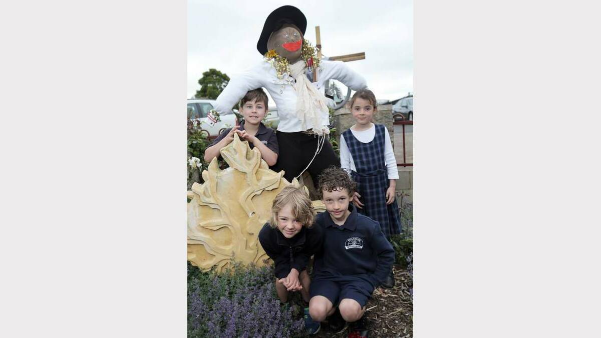 Pupils Cooper Ferris, 7 (left), Billy McPherson, 6, Arjay Van Bruggen, 8, and Amelia Rouse, 7, with one of the scarecrows made for the markets. 