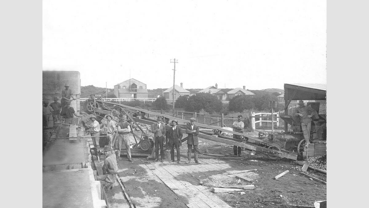 The tender for the construction of the Warrnambool breakwater was let in 1884 for a 1033 foot breakwater made of concrete blocks. This photo from 1890 shows the concrete blocks used in the construction located in the railway reserve beside the Merri River. The Stanley Street bridge (now renamed Edwards Bridge) is in the background. SOURCE: Warrnambool & District Historical Society.