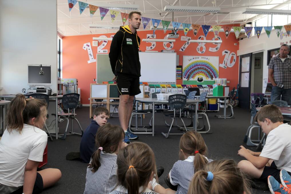 Richmond AFL player Orren Stephenson talks to students at Panmure Primary School, as part of the club's Community Camp in Warrnambool. 