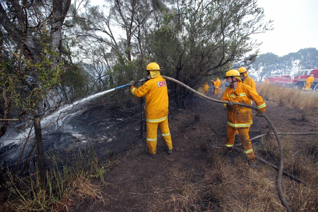 Firefighters took measures to stop embers from reaching farm land. 