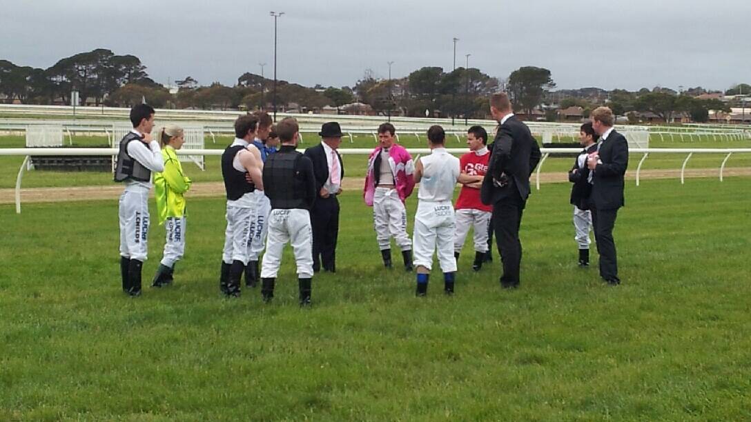 Jockeys inspecting and discussing a hole in the track at Oaks Day. Picture: AIDAN FAWKES