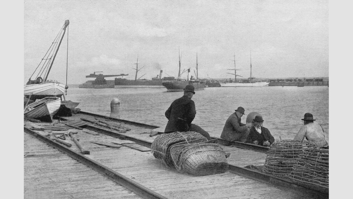 This photograph of some men sitting at the Warrnambool breakwater dates back at least a century and captures a moment in the evolving history of the harbour. SOURCE: Warrnambool & District Historical Society.