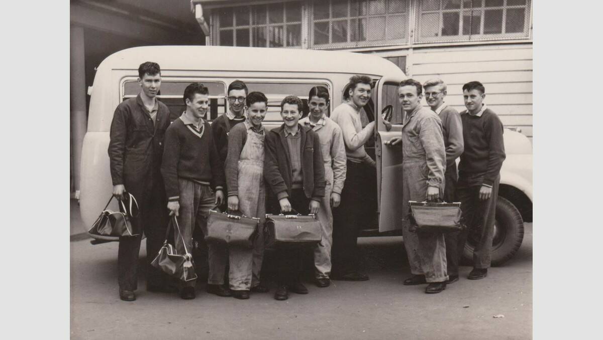 Based purely on the haircuts, fashions, the mini-bus and those nifty Gladstone bags, this image appears to date to the mid-1950s to mid-’60s. The lads appear to be trade students/trainees at an educational institution. SOURCE: Warrnambool Library.