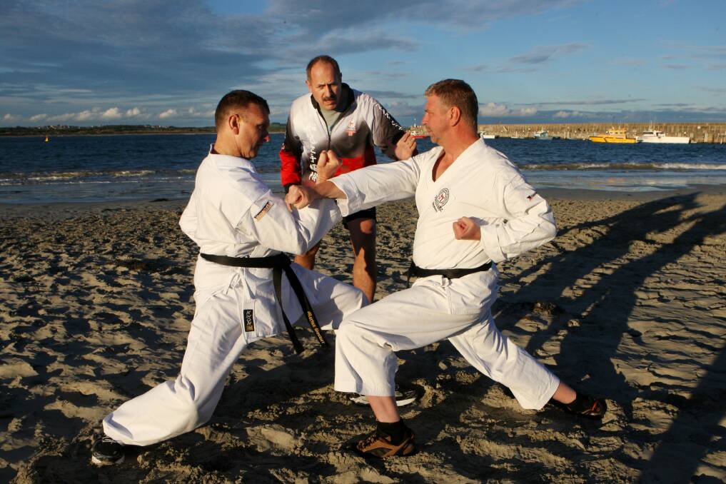 Marius Bouwer from Germany, Frank McKenzie from Warrnambool Funakoshi Karate International and Matthias Pliszka from Funakoshi Karate International Germany practicing on the sand at Lady Bay. Picture:LEANNE PICKETT