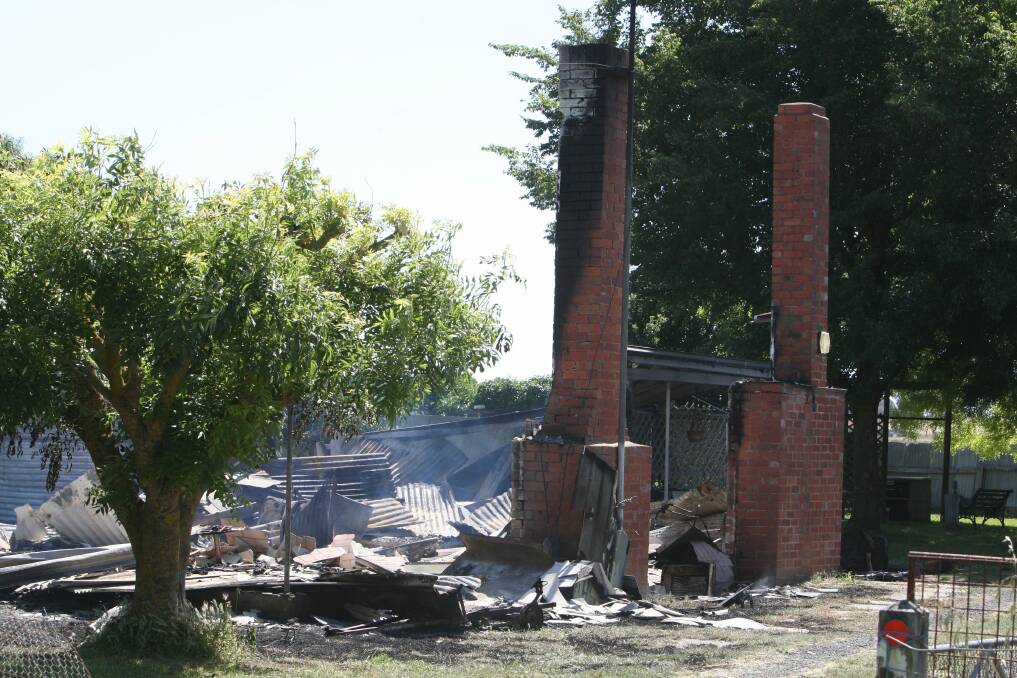 Smoke wafts from the remains of the destroyed home yesterday.