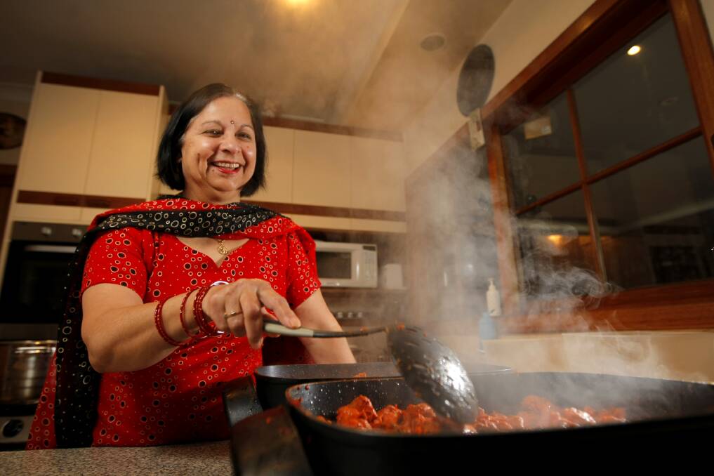 Indian cook Rekha Dart preparing butter chicken ahead of the Winter Fusion Dinner at St Brigid's Hall.