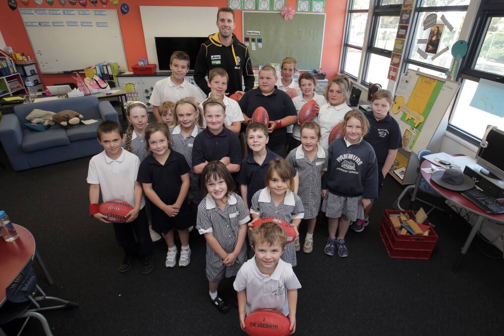 Richmond AFL player Orren Stephenson with students of Panmure Primary School, as part of the club's Community Camp in Warrnambool. 