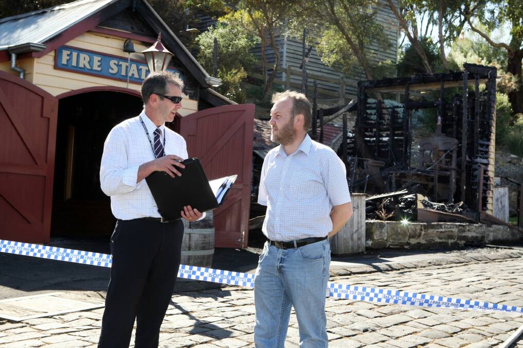 Detective Senior Constable Jason Bourke from Warrnambool CIU talks to Flagstaff Hill's Peter Abbott as they look at the damage.