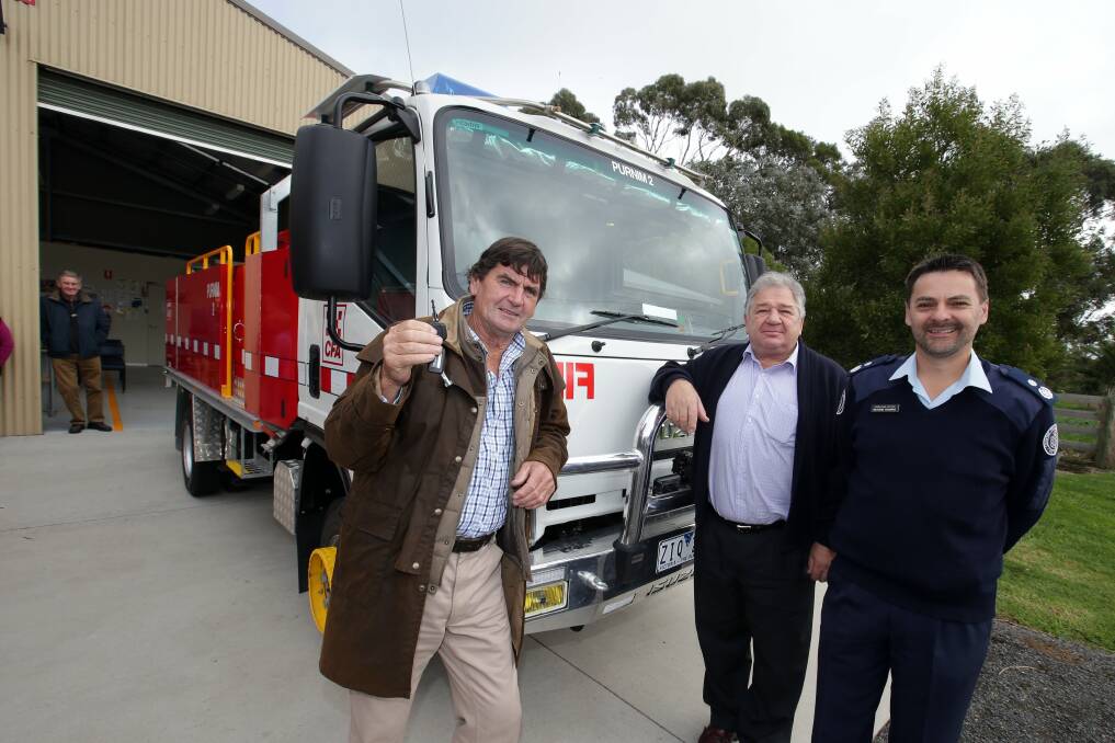 Purnim Captain David MacDonald with keys to a new tanker, and Moyne mayor Jim Doukas with District 5 acting operations manager Richard Bourke.