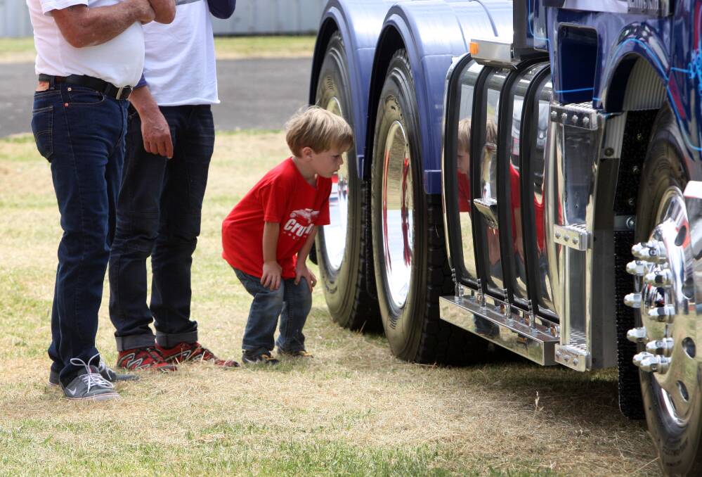 Harry Haylock, 3, from Port Fairy looking at a Mack truck owned by Boyles Livestock in Mepunga.