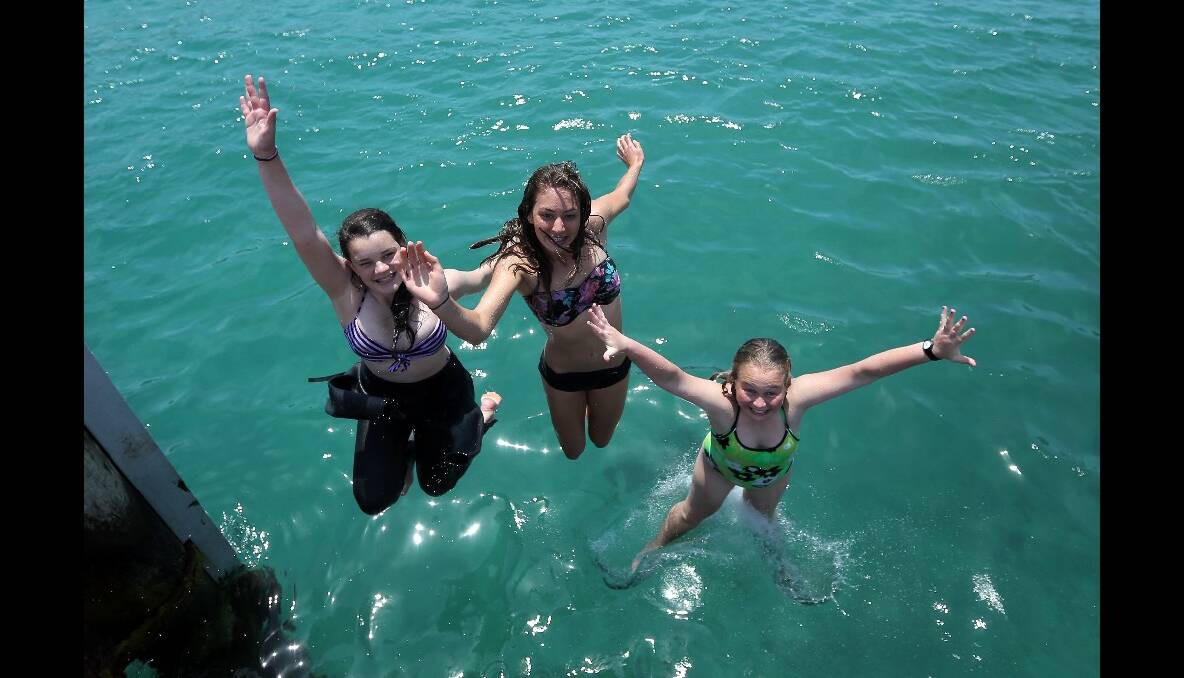 Gemma Lees, Ahliya Harris and Kate Delaney all from Port Campbell jumping from jetty at Port Campbell