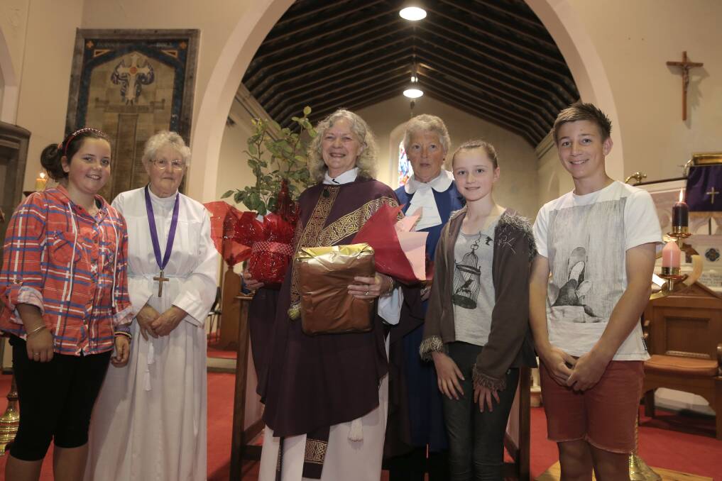 Newly ordained female priest Robyn Shackell receives gifts from parishioners, Rahni Radcliffe, 11, Della Bishop, Robyn Shackell, Agnes Johnson, Hannah Loughhead, 11, and Michael Loughead, 14.