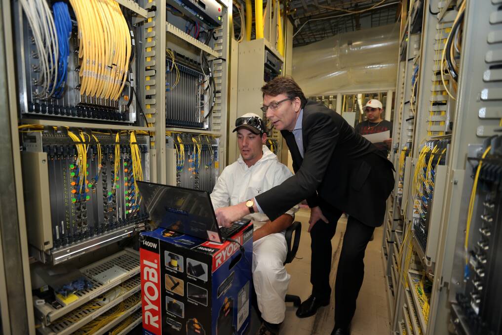 Telstra CEO David Thodey inspecting the Warrnambool exchange building and speaking to technician from T.E.N Brodie Montague. 