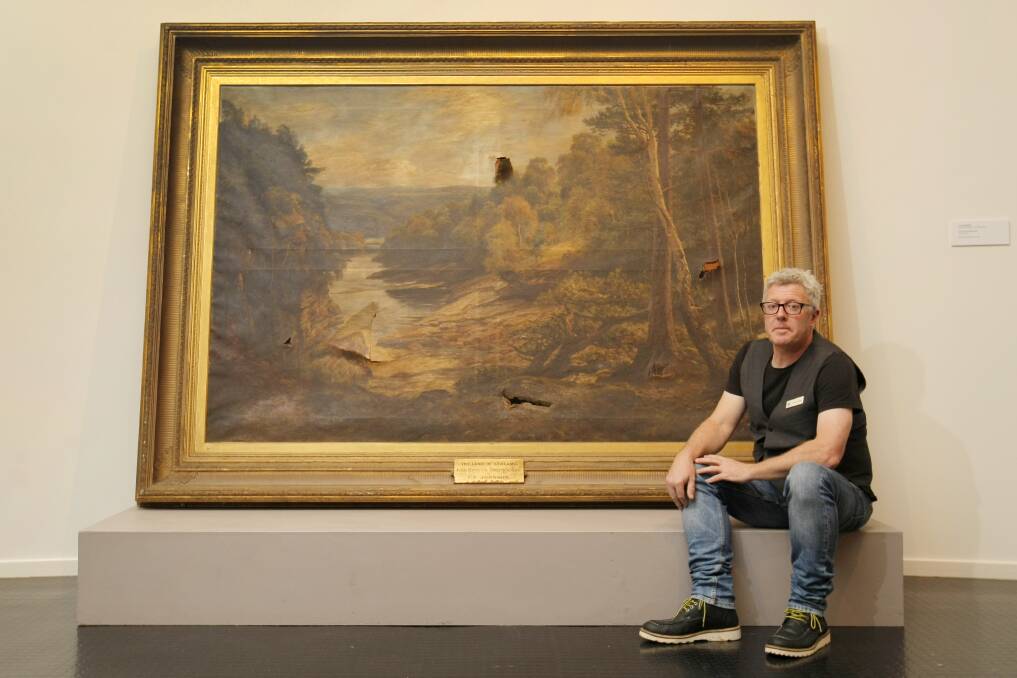 Warrnambool Art Gallery curator Murray Bowes with the painting "The Land of Streams" by C.E. Johnson which is on display to talk about art conservation. Picture: ROB GUNSTONE
