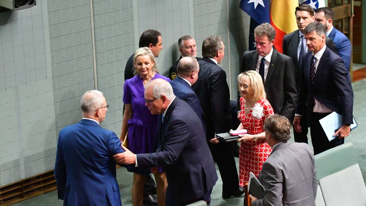 Liberal MPs congratulate Scott Morrison after censure speech. Picture by Elesa Kurtz