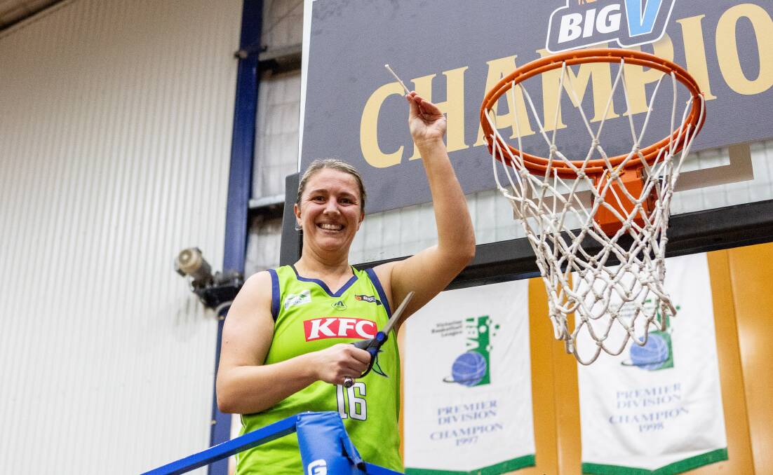 Louise Brown cuts down the net after the Mermaids Big V division one title win this year. Picture by Anthony Brady