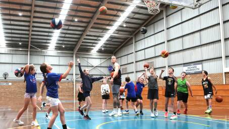 NBL superstar Mitch Creek overseeing a drill with Terang junior basketballers. Picture by Anthony Brady