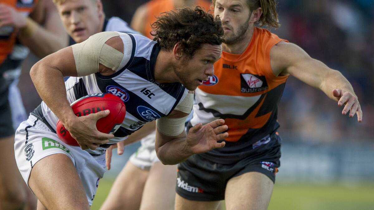 Steven Motlop tries to get past GWS player Callan Ward while playing for Geelong in 2015. Picture by Canberra Times