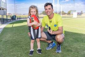 Umpire Josh McMahon with daughter Raffy, 3, at Reid Oval. Picture by Eddie Guerrero