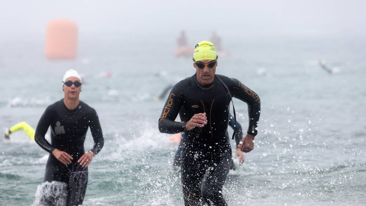 A determined Brett Trace finishes the swim leg in foggy conditions. Picture by Anthony Brady