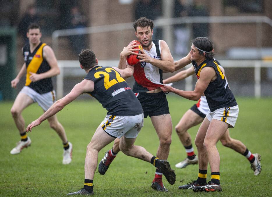 Koroit's Jayden Whitehead tries to break free of his Portland opponents. Picture by Sean McKenna