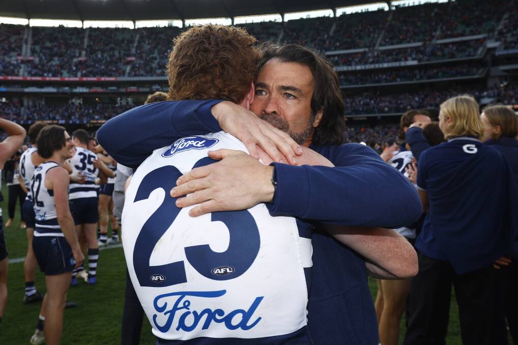 Emotions run high as Gary Rohan embraces Cats coach Chris Scott after Geelong won the AFL grand final. Picture by Getty Images