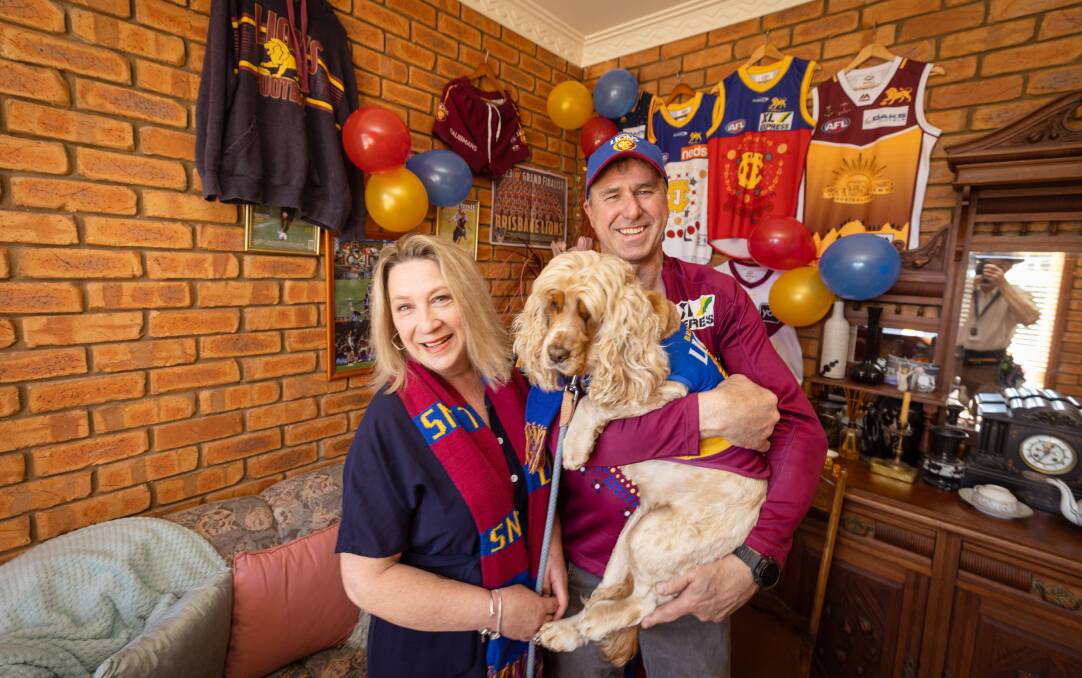 Zac Bailey's dad Brent Bailey (right) with his partner Jorgie Sarahs and Chai the dog in Portland ahead of the AFL grand final. Picture by Sean McKenna