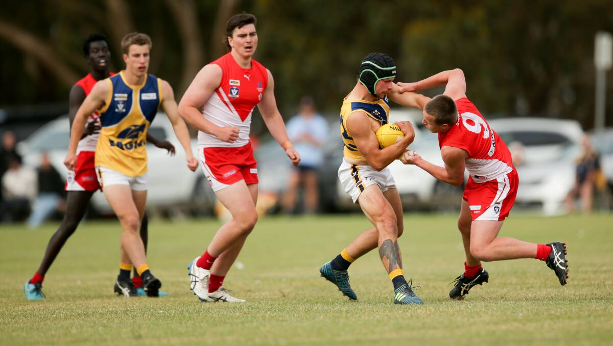 Dion Johnstone fends off a South Warrnambool Rooster in 2021. Picture by Anthony Brady