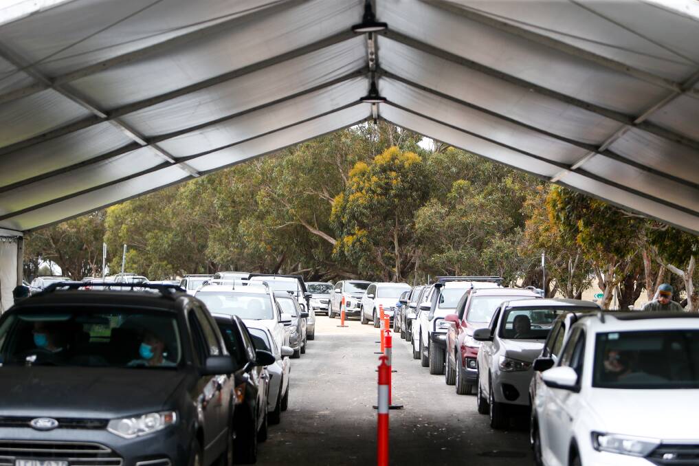 Endless: Even in the early morning the queue of cars at the new pop-up testing facility at the Deakin University campus stretched hundreds of metres. Picture: Anthony Brady.