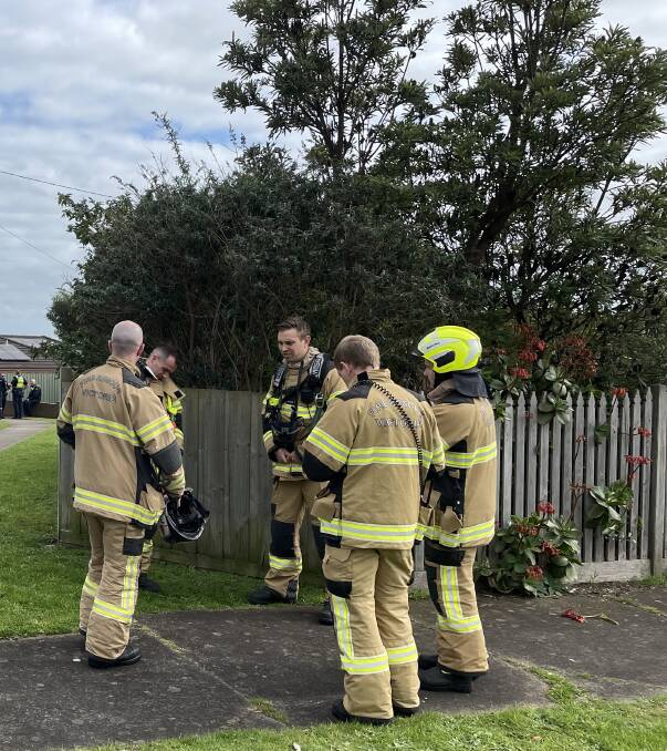 Fire Rescue Victoria on standby at the scene of a siege in Warrnambool, where a man was threatening to burn down a house. Picture by Ben Silvester