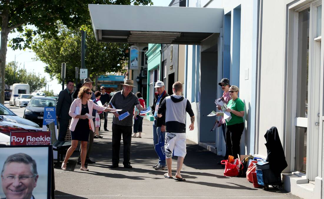 Volunteers hand out how-to-vote cards in Warrnambool on election day for the 2014 Victorian state election, when Premier Denis Napthine squared off against Labor's Roy Reekie for the honour of representing South West Coast.
