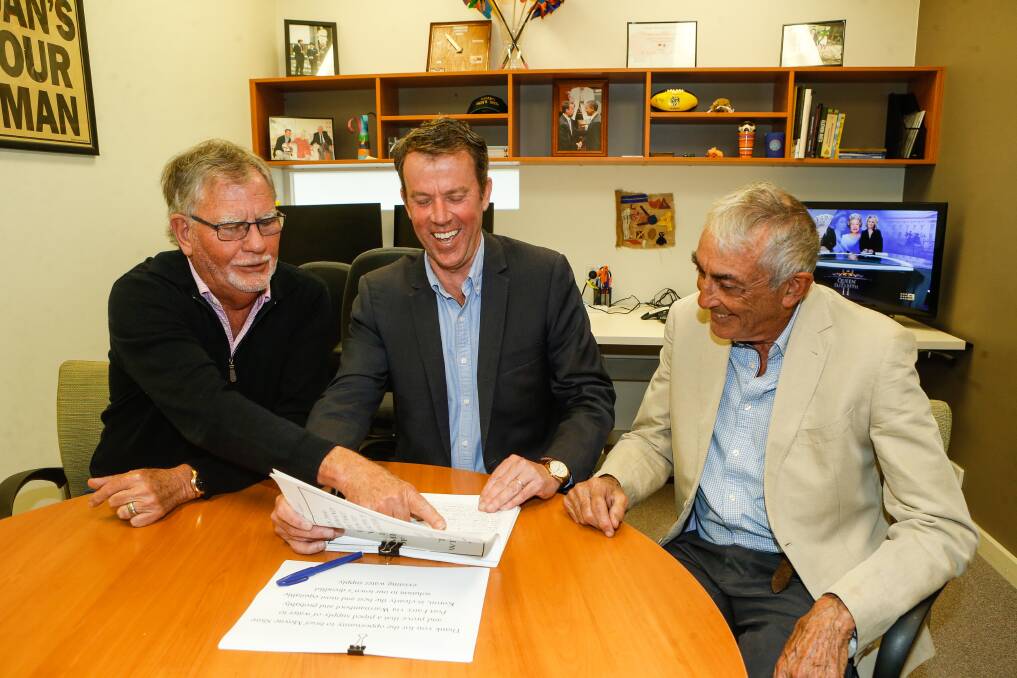 John Konings, Member for Wannon Dan Tehan, and David McLean review the 2100-signature petition calling for Wannon Water to build a drinking water pipeline to Port Fairy. Picture by Anthony Brady