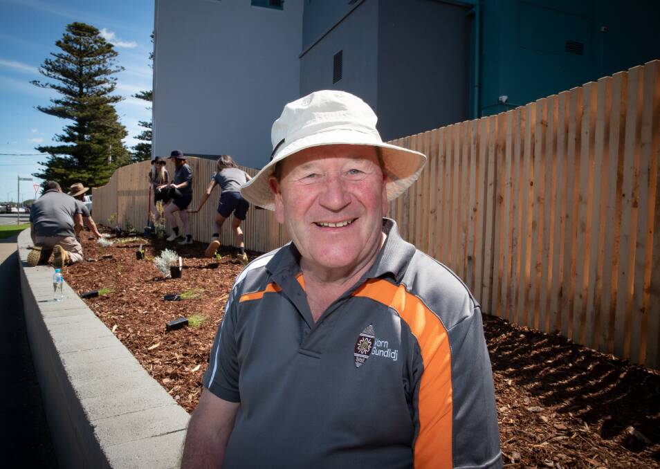 Worn Gundidj Nursery manager Peter Lyles is all smiles as his team plants a garden at South West TAFE using only native plants harvested from the Warrnambool foreshore. Picture by Sean McKenna