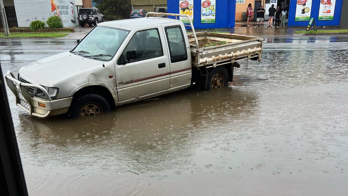 A ute out the front of Heywood Laundry Service is cut off by floodwaters on the afternoon of January 7, 2023. Picture by Raelene Alexander