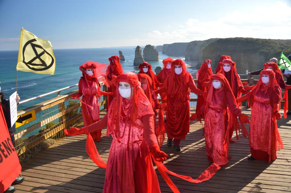 Striking: The Red Rebels performance artists performed at the 12 Apostles in July last year to protest gas exploration in the area. Picture: Alan Northey.