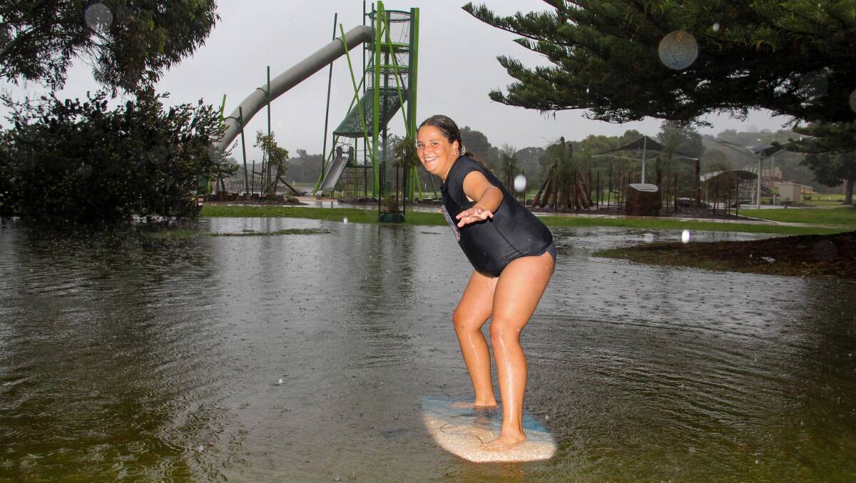 Holly Butterworth, 12, from Melbourne, at Lake Pertobe during heavy rain in Warrnambool. Picture: Anthony Brady