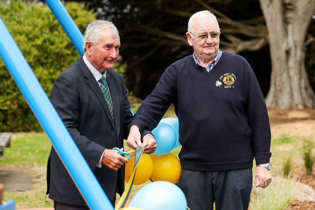 Officially open: New Moyne mayor Ian Smith cuts the ribbon at the new Martins Point playground along with Port Fairy Belfast Lions Club president Keith Dawson. Picture: Morgan Hancock.