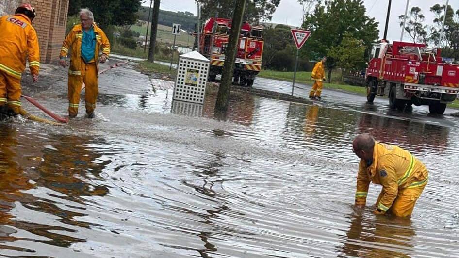 CFA volunteers work to clear floodwater from Heywood's main street. Picture by Heywood Fire Brigade