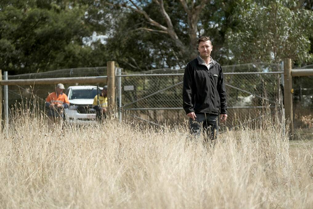 Department of Environment, Land, Water and Planning natural environment program officer Jonathan Lee at the new predator-proof fence at Hamilton Sanctuary. 