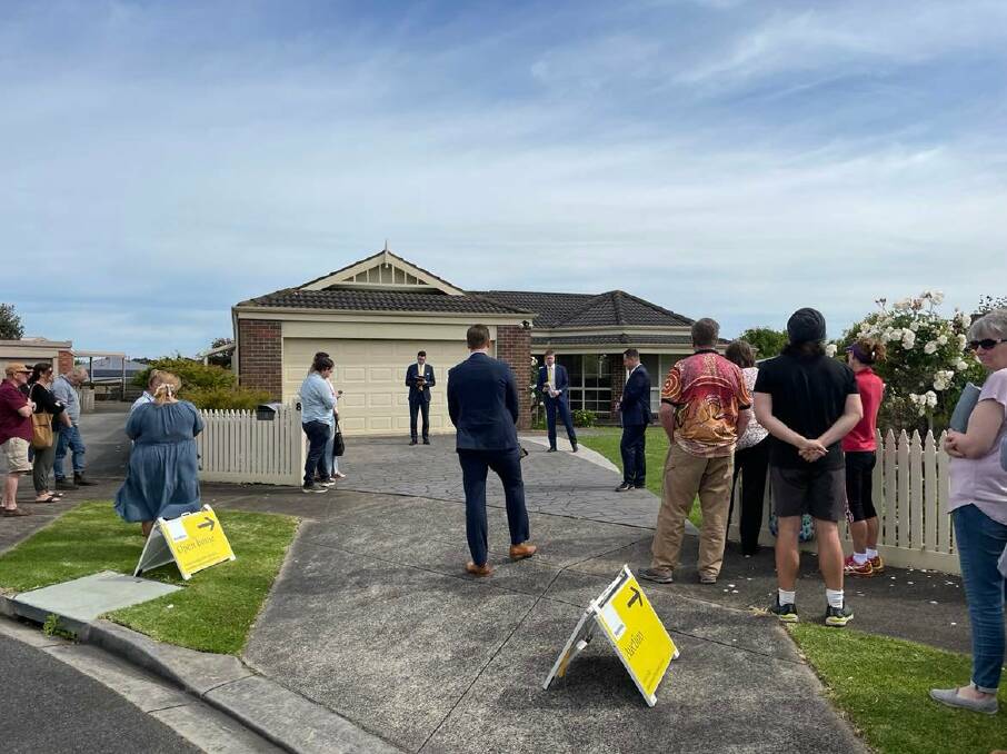 Ray White's Fergus Torpy with a crowd of about 35 people outside 8 Eliza Court, Warrnambool. 