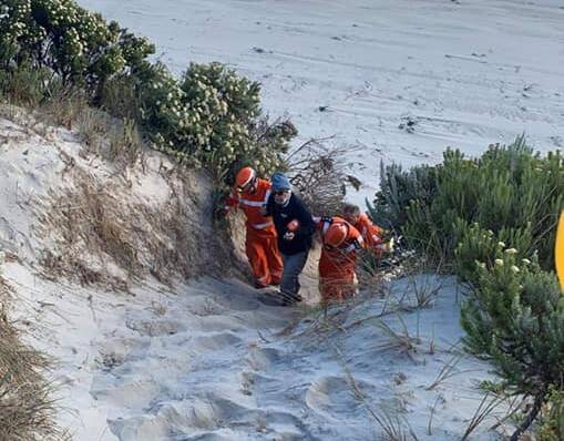 RESCUED: Portland SES members assisting the injured hiker back to the ARGO vehicle. Picture: Supplied
