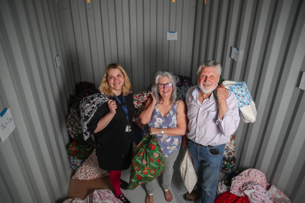 SPREAD JOY: Brophy's Natalie Bignell with Backpacks 4 Vic Kids' Jennifer and Peter King in the free storage unit provided by Owen Truss. Picture: Morgan Hancock