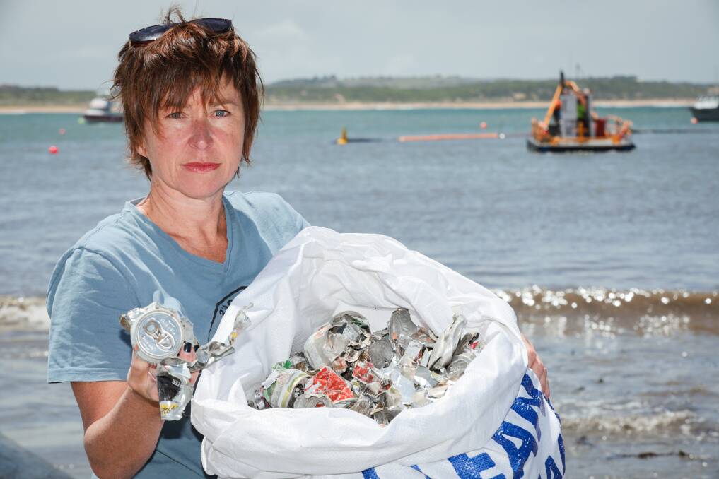 Colleen Hughson with some of the litter she's collected near the dredging works at Warrnambool breakwater. Picture by Sean McKenna