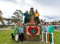 Loretta Gurnett (top left) stands with Koroit's spud-picker statue, adorned with a coat of crocheted shamrocks, and other members of the Country Women's Association who helped to create them. Picture by Anthony Brady