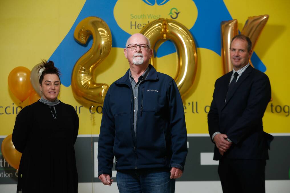 NORMAL LIFE: COVID-19 coordinator Sue Anderton, vaccination recipient Ian Sadler and chief executive officer Craig Fraser at the celebration on Tuesday. Ian received the 20,000th vaccine dose at South West Healthcare.